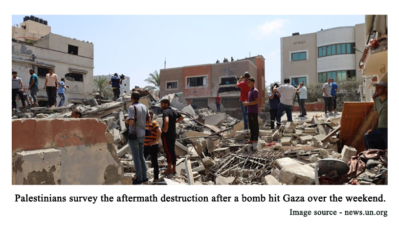 Palestinians survey the aftermath destruction after a bomb hit Gaza over the weekend.